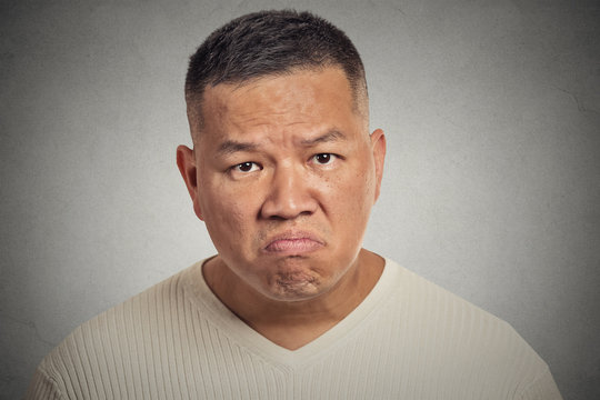 grumpy offended man isolated on grey wall background