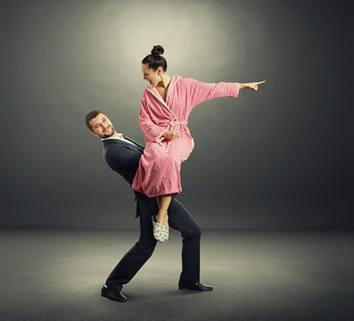smiley man holding screming woman
