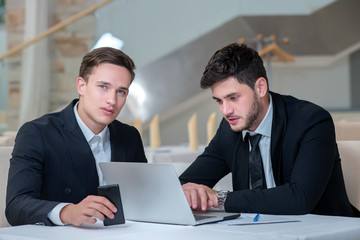 Two successful businessmen are working on the project