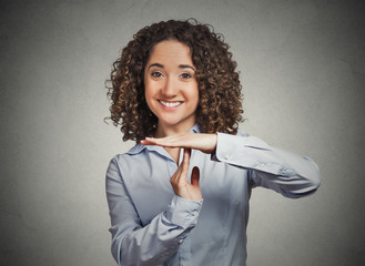 smiling woman showing time out gesture with hands