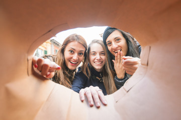 Happy Women Looking into Shopping Bag