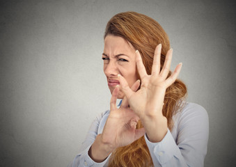 Headshot Disgusted woman isolated on grey wall background 