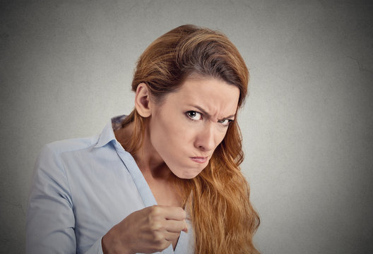 portrait angry woman on grey background. Negative emotion