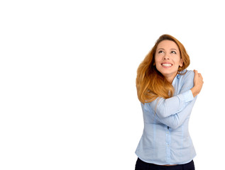 woman holding hugging herself looking up at copy space