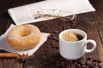 Coffee with donut and newspaper