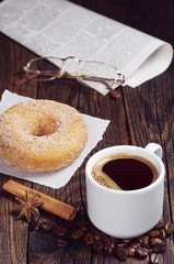 Coffee, donut, newspaper and glasses