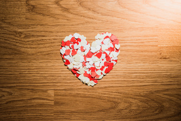 many red and white heart on a wooden background