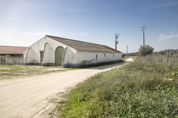 warehouse and a rural dirt road in the countryside