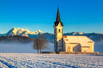 St. Florian church with a view of the alps in the morning