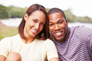 Portrait Of Happy Young Couple In Garden