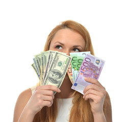 Happy young woman holding up cash money dollars and euros