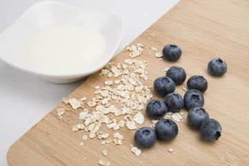 Oats, Bluberries, Milk and Wood Cutting Board