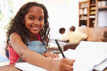 Portrait Of Girl Doing Homework At Table