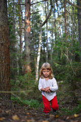 Running little girl in the forest