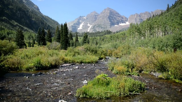 Maroon Bells with stream and blue sky, Colorado