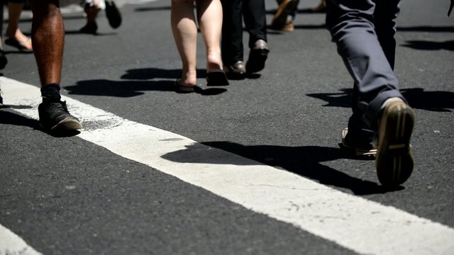 Crowds of people crossing street at intersection in Sydney