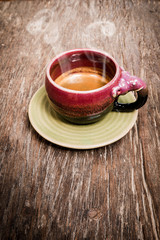 An elephant cup of espresso on wooden background