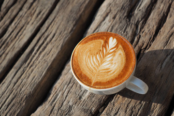 cup of coffee latte art on the wood background in vintage color