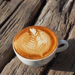 cup of coffee latte art on the wood background in vintage color
