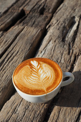 cup of coffee latte art on the wood background in vintage color
