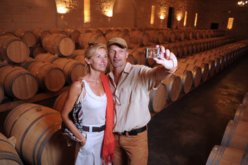 Tourism-Couple visiting a castle photographing in a barrel cella