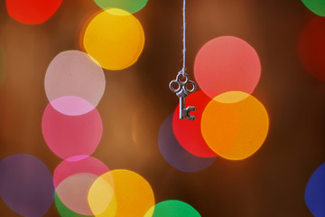 a decorative key hanging on wooden background