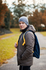 Fototapeta premium portrait of the young man with a backpack in outdoor