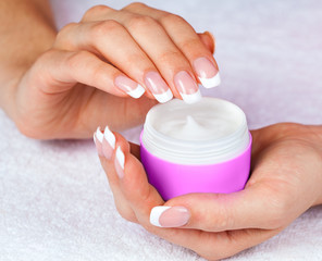 Female hands holding jar of cream