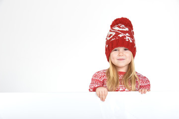 Smiling beautiful blond girl in a red winter cap and sweater wit
