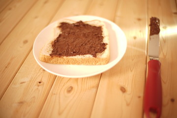 Spreading delicious peanut butter on white bread