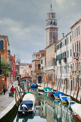 Fototapeta na wymiar Gondolas moored along water canal in Venice