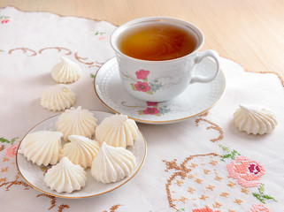 Still life with tea and a meringue.