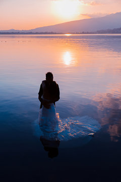 bride and groom on the water in the lake, trash the dress