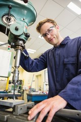 Engineering student using large drill