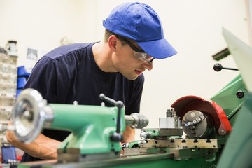 Engineering student using heavy machinery