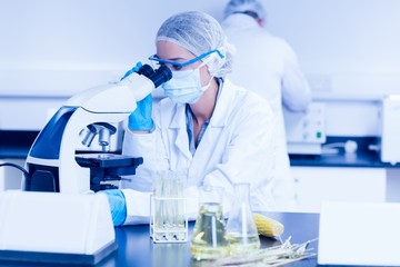 Food scientist using the microscope