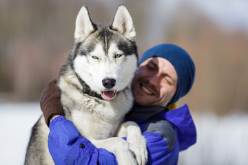 Happy man with a husky