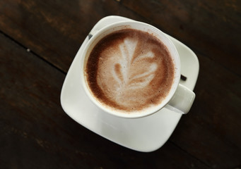 Hot chocolate in a white cup on table