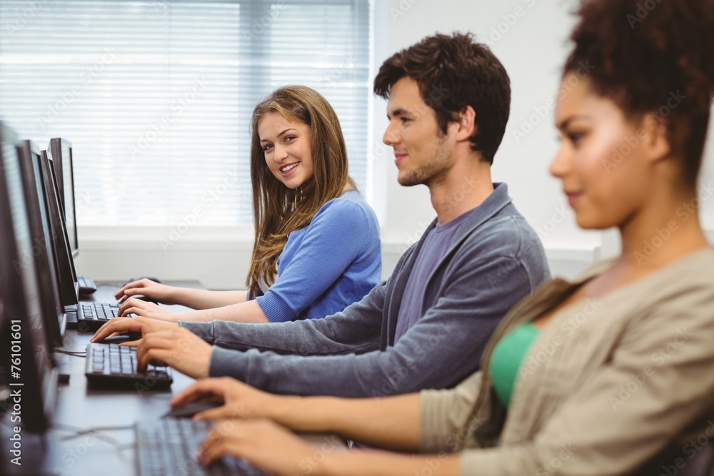 Poster Happy student in computer class smiling at camera