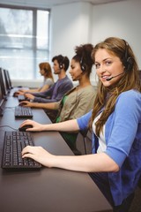 Happy student in computer class smiling at camera