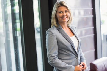 Blonde businesswoman smiling at camera