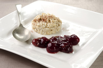 porridge with cherry on a plate