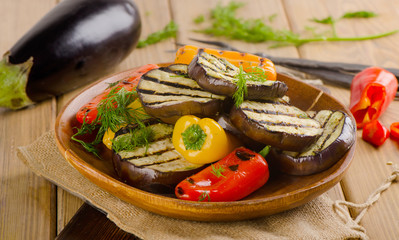 Grilled vegetables   on wooden   plate with fresh herbs.