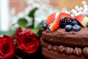 Dark Red Roses and Chocolate Cake with Berries