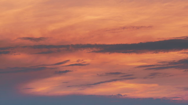 Time lapse shot of the evening sunset through the clouds