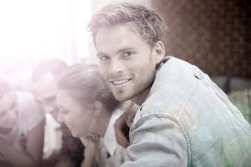 Fototapeta premium Portrait of handsome guy amongst group of friends
