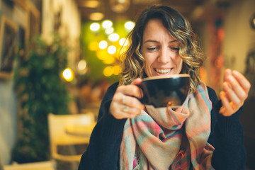 woman with smart phone in coffee shop