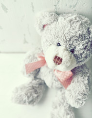 Vintage teddy bear with a pink ribbon