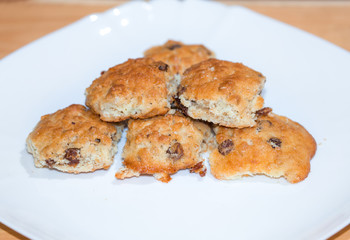 Handmade crisp biscuits with raisin on white plate