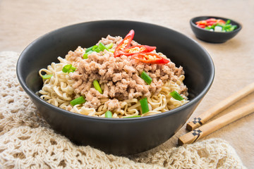 Instant noodles with pork in bowl